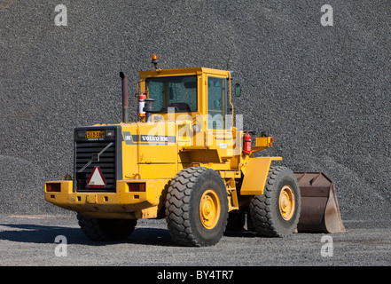Yellow Volvo BM L90C front loader and a pile of gravel , Finland Stock Photo