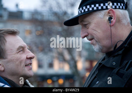 Singer/songwriter Hordur Torfason, main organiser and spokesperson of the Saturday protests speaking with the Chief of Police. Stock Photo