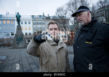 Singer/songwriter Hordur Torfason, main organiser and spokesperson of the Saturday protests speaking with the Chief of Police. Stock Photo