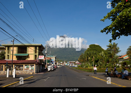 Morning clouds obscure the upper cone of the looming Arenal Volcano in La Fortuna de San Carlos, Alajuela, Costa Rica. Stock Photo