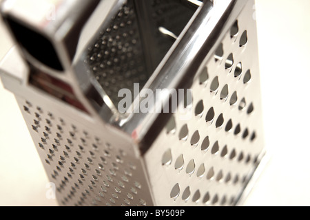 A stainless steel cheese grater used in the kitchen to grate cheese Stock Photo