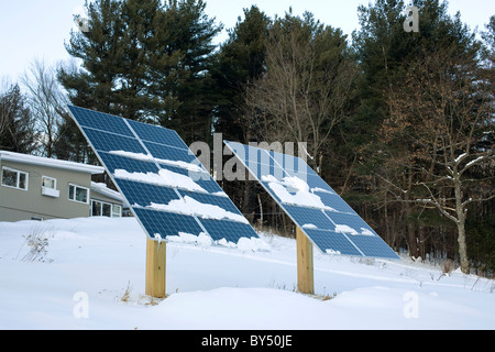 Large residential solar panels are at a home in Williamstown Massachusetts on a winter afternoon. Stock Photo