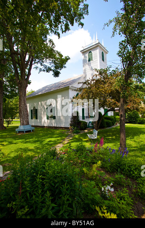 Garden in front of a white church building Stock Photo