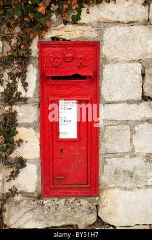 Old red GR post box set into the wall at Ruscombe near Stroud, Gloucestershire, England, United Kingdom Stock Photo