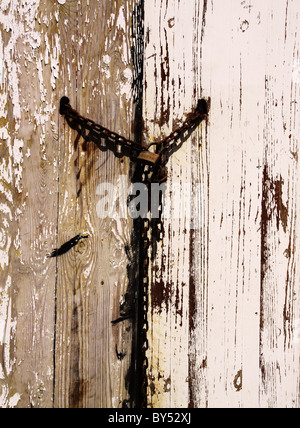 Rusty chain and padlock on weathered wooden gate Stock Photo