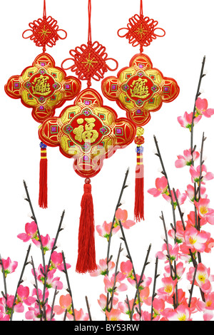 Chinese New Year traditional ornaments and plum blossom on white background Stock Photo