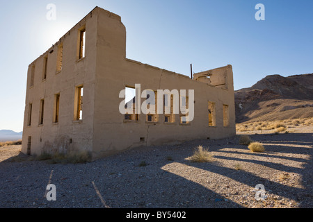 Ruins of the two story eight-room schoolhouse in the Nevada ghost town Rhyolite on the edge of Death Valley was founded in 1904 and abandoned by 1916. Stock Photo