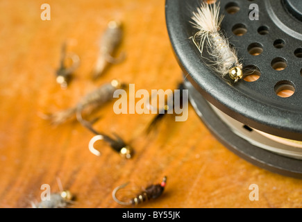 A nymph style fly on a fly reel Stock Photo