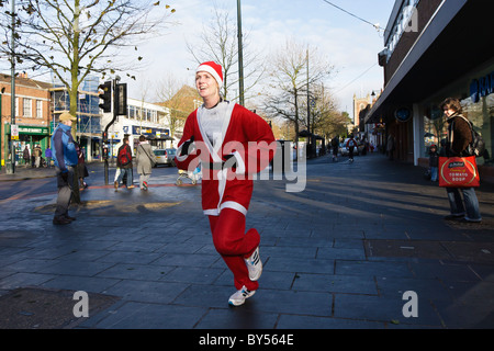 Young women runner in Santa outfit during 2010 St Albans Jingle Bell Jog fun run Stock Photo