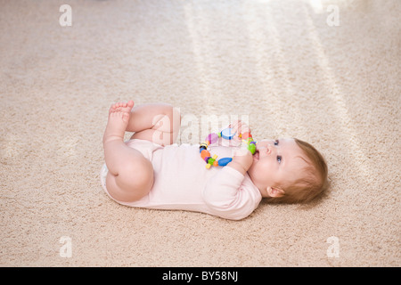A baby biting a teething ring Stock Photo