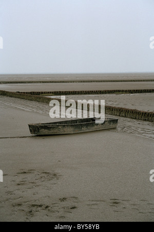 Boat stuck on beach shore Stock Photo