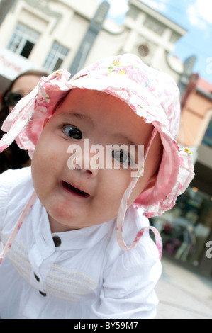 Ten month old baby girl looking intently at the camera Stock Photo