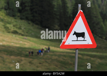 An animal crossing sign in front of a green landscape Stock Photo