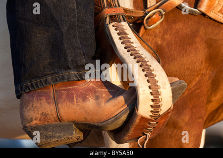 A cowboy boot in a horse stirrup, detail Stock Photo