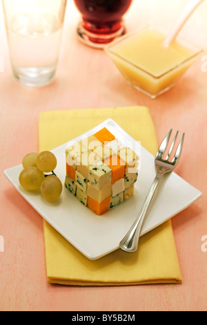 Cheese cube with grape coulis. Recipe available. Stock Photo