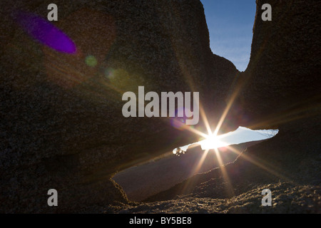 Sunlight shines through granite rock formations in Joshua Tree National Park, California, USA. Stock Photo