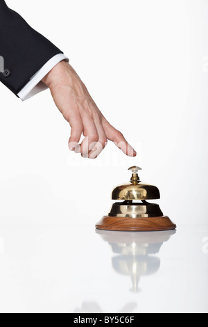 A man pressing a service bell, focus on hand Stock Photo
