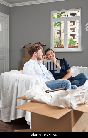 A couple relaxing on a sofa Stock Photo