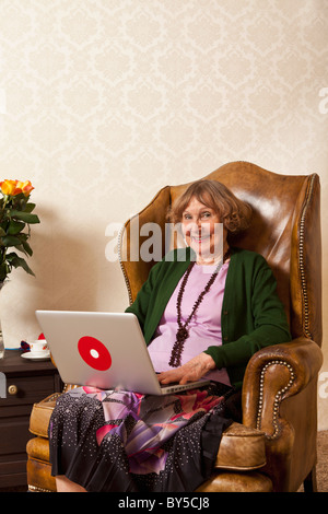 A happy senior woman using a laptop Stock Photo