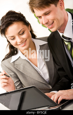 Vertical image of businessman and businesswoman doing some computer work together Stock Photo