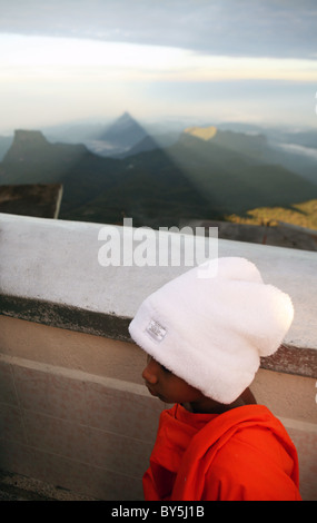 Sun rise casts a perfectly formed triangular shadow of  Sri Pada or Adam’s Peak on to the surrounding countryside. Sri Lanka. Stock Photo