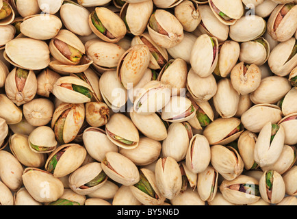 background of roasted pistachio nuts in their shells Stock Photo