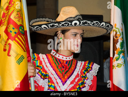 young lady woman with Mexican Flag dancers Mexican style costumes hats beautiful young people posing Stock Photo