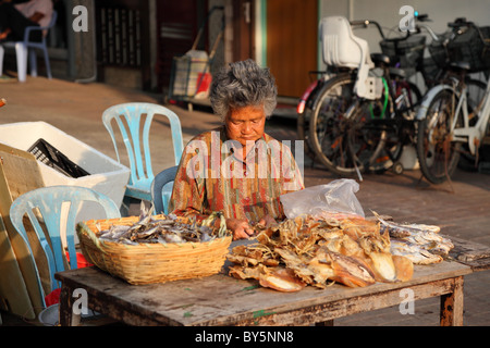 Woman selling dried fish at street market in Cheung Chau, Hong Kong Stock Photo