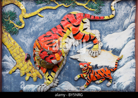 Tiger family on the wall of taoist temple in Hong Kong Stock Photo