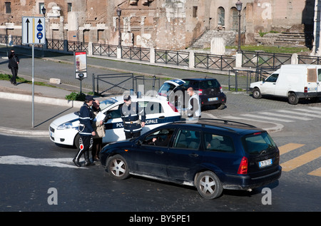 Italian police 'Police Municipale' roadblock checking car vehicle in street of Rome, Italy. Stock Photo