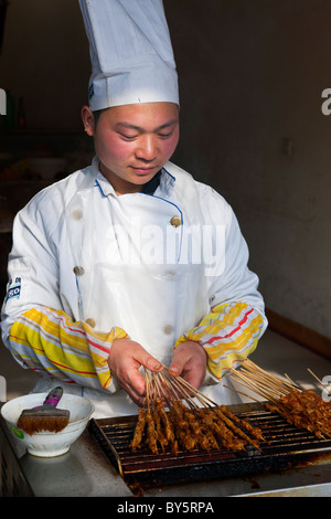 Street kebab fast food seller in the ancient town of Huanglongxi near Chengdu in the Sichuan Province of China. JMH4345 Stock Photo