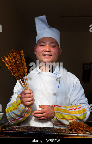 Street kebab fast food seller in the ancient town of Huanglongxi near Chengdu in the Sichuan Province of China. JMH4346 Stock Photo