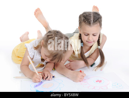 Two sisters draw on the album. Stock Photo