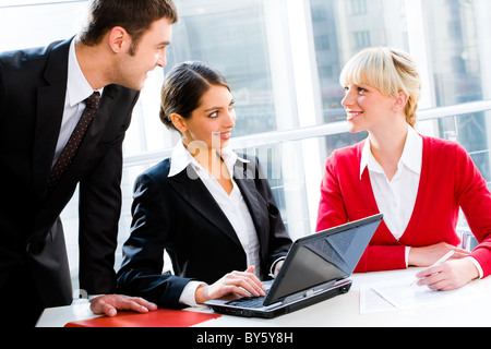 Portrait of business people looking at woman at working meeting Stock Photo