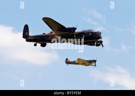 An Avro Lancaster and Vickers Supermarine Spitfire of the Battle of Britain Memorial flight in close formation Stock Photo