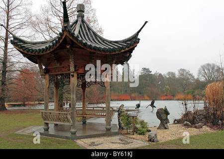 Japanese Pagoda and sculptures at the frozen lake in Seven Acres, RHS Garden Wisley, Surrey, England, Great Britain, UK, Europe Stock Photo