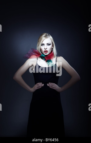 Top model in elegant dress with perfect makeup on a dark background Stock Photo