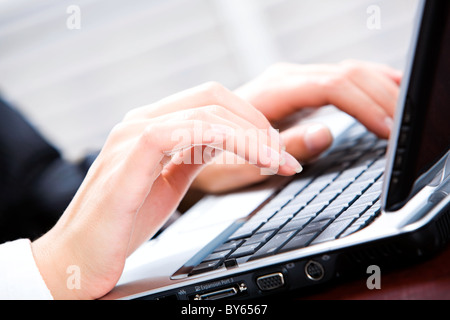 Creative image of human hands using a laptop Stock Photo
