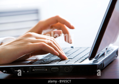 Image of female hands on the keys typing documents Stock Photo