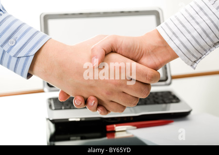 Symbol of partnership: business people shaking hands Stock Photo