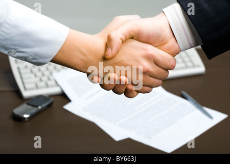 Successful deal: people shaking hands at business meeting Stock Photo
