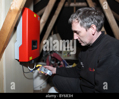 Measuring the output from roof mounted solar photo voltaic panels at the inverter. Stock Photo