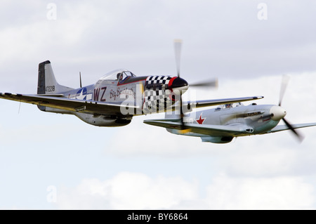 North American P-51D Mustang 'Big Beautiful Doll' and Yakovlev Yak-3UA in a formation flypast at Duxford Flying Legends Airshow Stock Photo