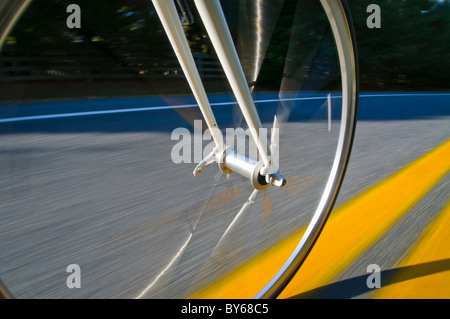 Rolling bicycle wheel Stock Photo