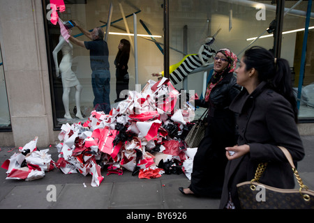 Pedestrians walk past the display window of jeweller Bulgari at