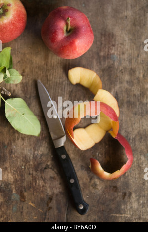 peeled apples on table with knife Stock Photo