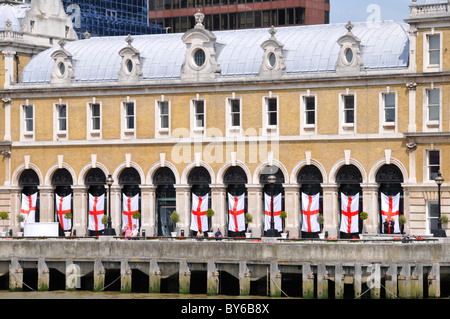 Old Billingsgate Fish Market building beside River Thames now used for hospitality events thus St Georges Cross banner flag City Of London England UK