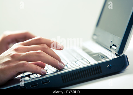 Image of human hands typing on laptop Stock Photo