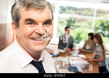 Photo of confident older chief smiling in the office Stock Photo