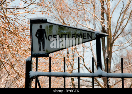 Gentlemen restroom sign in snow Stock Photo